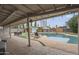 Spacious backyard featuring a sparkling pool, outdoor dining, and covered patio areas at 6251 E Hannibal St, Mesa, AZ 85205