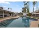 Spacious backyard with inviting pool, lush landscaping, and a covered patio area at 6251 E Hannibal St, Mesa, AZ 85205