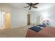 Spacious bedroom with ceiling fan, carpet flooring, and ample closet space at 6251 E Hannibal St, Mesa, AZ 85205