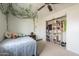 Cozy bedroom featuring decorative vines, ceiling fan, and a closet for ample storage at 6251 E Hannibal St, Mesa, AZ 85205