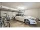 Attached garage with a white car, bikes, and an automatic garage door opener at 6251 E Hannibal St, Mesa, AZ 85205