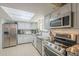 Well-lit kitchen featuring stainless steel appliances and granite countertops at 6251 E Hannibal St, Mesa, AZ 85205