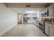 Spacious kitchen featuring stainless steel appliances, an island, tile floors, and a skylight at 6251 E Hannibal St, Mesa, AZ 85205