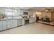 Bright kitchen with stainless steel appliances, granite countertops, tile floors, and breakfast bar at 6251 E Hannibal St, Mesa, AZ 85205