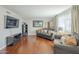 Comfortable living room with hardwood floors, gray couches, and ample natural light at 6251 E Hannibal St, Mesa, AZ 85205
