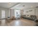 Bright living room showcasing wood flooring, modern seating, and sheer curtains at 6251 E Hannibal St, Mesa, AZ 85205