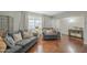 Inviting living room with hardwood floors, gray couches, and neutral decor accents at 6251 E Hannibal St, Mesa, AZ 85205