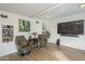 Inviting living room with twin swivel chairs, greenery, and a mounted television at 6251 E Hannibal St, Mesa, AZ 85205