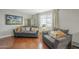 Comfortable living room featuring neutral walls, wood floors, and stylish gray couches at 6251 E Hannibal St, Mesa, AZ 85205