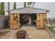 Outdoor shed with open doors and storage, located in the backyard at 6251 E Hannibal St, Mesa, AZ 85205