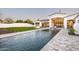 Luxury backyard with a sparkling pool, manicured lawn, and an inviting outdoor living space at 6500 E Cactus Wren Rd, Paradise Valley, AZ 85253