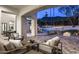 Outdoor entertaining area with a covered patio, comfortable seating, mountain views, fireplace and a pool at 6500 E Cactus Wren Rd, Paradise Valley, AZ 85253