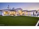 Sprawling backyard with lush lawn, private pool and spa, covered patio, and desert landscaping at 6500 E Cactus Wren Rd, Paradise Valley, AZ 85253