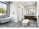 Bathroom featuring a soaking tub, dual vanity with dark wood cabinets, and stone flooring, with views to the outdoors at 6500 E Cactus Wren Rd, Paradise Valley, AZ 85253