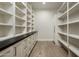 Spacious walk-in closet with custom shelving, drawers, and ample storage space at 6500 E Cactus Wren Rd, Paradise Valley, AZ 85253