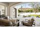 Relaxing covered patio with comfortable seating, travertine tile and picturesque mountain views at 6500 E Cactus Wren Rd, Paradise Valley, AZ 85253