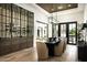 Elegant dining area includes a custom wine rack and stylish light fixture and backyard views through steel-framed glass doors at 6500 E Cactus Wren Rd, Paradise Valley, AZ 85253