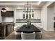 Stylish dining area with designer lighting, custom cabinetry, and backyard views through steel-framed glass doors at 6500 E Cactus Wren Rd, Paradise Valley, AZ 85253