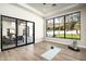 Versatile flex space featuring hardwood floors, a large window, and access to the patio at 6500 E Cactus Wren Rd, Paradise Valley, AZ 85253