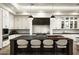 Spacious kitchen with a large central island, stylish pendant lights, and lots of counter seating at 6500 E Cactus Wren Rd, Paradise Valley, AZ 85253