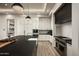 Modern kitchen with a large island, stainless steel appliances, custom cabinets, and granite countertops at 6500 E Cactus Wren Rd, Paradise Valley, AZ 85253