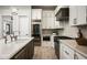 Modern kitchen featuring stainless steel appliances, marble countertops, and custom cabinetry at 6500 E Cactus Wren Rd, Paradise Valley, AZ 85253