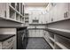 Functional laundry room with modern washer and dryer, sleek countertops and ample cabinet space at 6500 E Cactus Wren Rd, Paradise Valley, AZ 85253