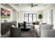 Spacious living room with a cozy sectional, large window, entertainment center, modern décor, and stylish seating at 6500 E Cactus Wren Rd, Paradise Valley, AZ 85253