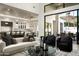 Bright and airy living room with high ceilings and an open view of the gourmet kitchen at 6500 E Cactus Wren Rd, Paradise Valley, AZ 85253
