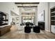 Bright living room boasts high ceilings, wood floors, fireplace, and large windows overlooking a lush backyard at 6500 E Cactus Wren Rd, Paradise Valley, AZ 85253