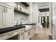 Well-organized mudroom with built-in cabinets, countertop space, and a convenient sink at 6500 E Cactus Wren Rd, Paradise Valley, AZ 85253