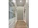 Bright walk-in closet with custom shelving, drawers, and glass door cabinets at 6500 E Cactus Wren Rd, Paradise Valley, AZ 85253
