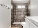 Modern bathroom features a tiled shower with glass door and stylish fixtures at 6817 W Palm Ln, Phoenix, AZ 85035