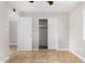Bedroom features tile floors and closet at 6817 W Palm Ln, Phoenix, AZ 85035