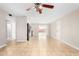 Open-concept living room with tile flooring, a ceiling fan, and easy access to the kitchen at 6817 W Palm Ln, Phoenix, AZ 85035