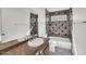 Bathroom featuring tile accents, white fixtures, and a shower-tub combination at 7102 W Julie Dr, Glendale, AZ 85308