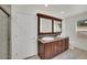 Bathroom featuring a double sink vanity with granite counters, and framed mirrors at 7102 W Julie Dr, Glendale, AZ 85308