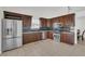 Stylish kitchen with stainless steel appliances, tile backsplash, and dark wood cabinetry at 7102 W Julie Dr, Glendale, AZ 85308