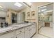 Bright bathroom with dual sinks, ample counter space, decorative lighting, and plenty of mirrors at 7121 E Mcdonald Dr, Paradise Valley, AZ 85253