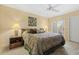 Tranquil bedroom featuring a decorative ceiling fan, a patterned bedspread, and neutral walls at 7121 E Mcdonald Dr, Paradise Valley, AZ 85253
