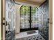 Arched front gate seen from the interior, accent rug, and tiled floor at 7121 E Mcdonald Dr, Paradise Valley, AZ 85253