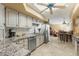 Bright kitchen with stainless steel appliances, white cabinets, granite countertops, and tile flooring at 7121 E Mcdonald Dr, Paradise Valley, AZ 85253