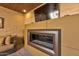 Modern fireplace below a mounted TV, providing an inviting ambiance and a contemporary aesthetic at 7121 E Mcdonald Dr, Paradise Valley, AZ 85253
