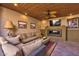 Cozy living space with comfortable couches, TV, fireplace, wood ceiling and tile floor to relax and enjoy time at 7121 E Mcdonald Dr, Paradise Valley, AZ 85253