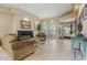 Spacious living room featuring a fireplace, comfortable seating, and abundant natural light from large windows at 7121 E Mcdonald Dr, Paradise Valley, AZ 85253