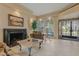 Inviting living room with tiled floors, fireplace, shutters, and elegant furniture at 7121 E Mcdonald Dr, Paradise Valley, AZ 85253