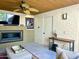 Cozy living room features a fireplace, TV, and a unique ceiling fan and wood ceiling at 7121 E Mcdonald Dr, Paradise Valley, AZ 85253
