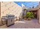Outdoor patio featuring a grill, spiral staircase, string lights and elegant decor with access to a cozy living space at 7121 E Mcdonald Dr, Paradise Valley, AZ 85253