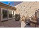 Outdoor patio featuring a grill, dining seating, string lights and elegant decor with access to the house through sliding doors at 7121 E Mcdonald Dr, Paradise Valley, AZ 85253
