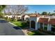 Charming street view featuring well-maintained lawns, white homes with Spanish tile roofs, and manicured bushes at 7121 E Mcdonald Dr, Paradise Valley, AZ 85253